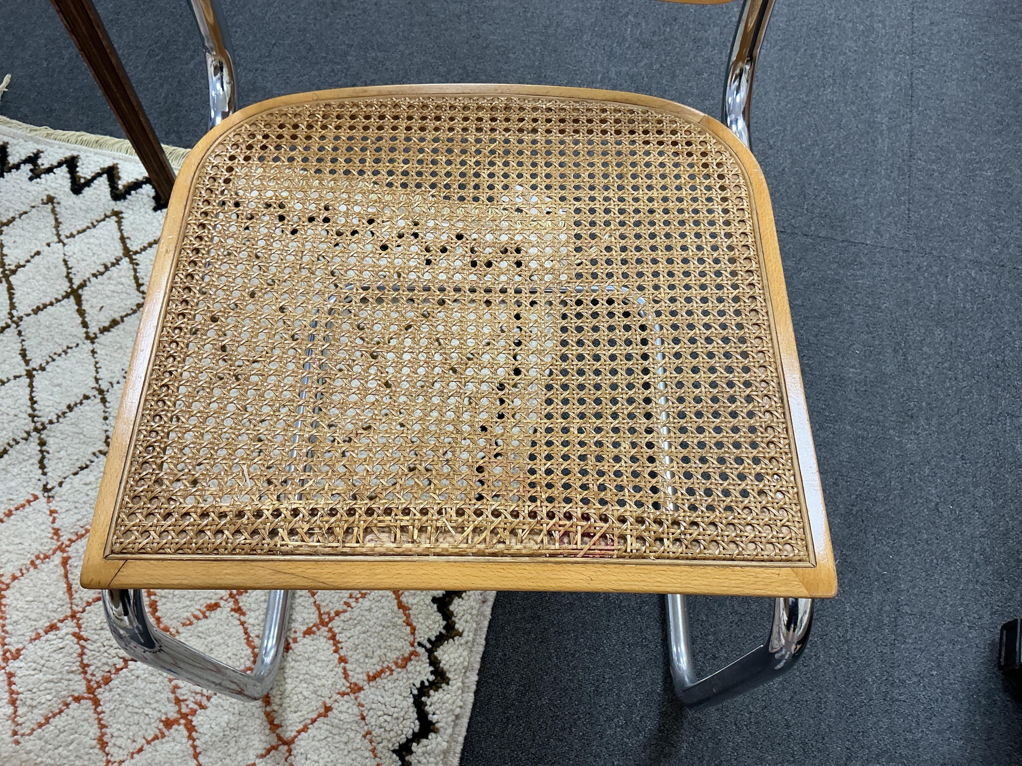 After Marcel Breuer a Cesca style circular table, diameter 112cm, height 72cm and four caned cantilever chairs, possibly Habitat.